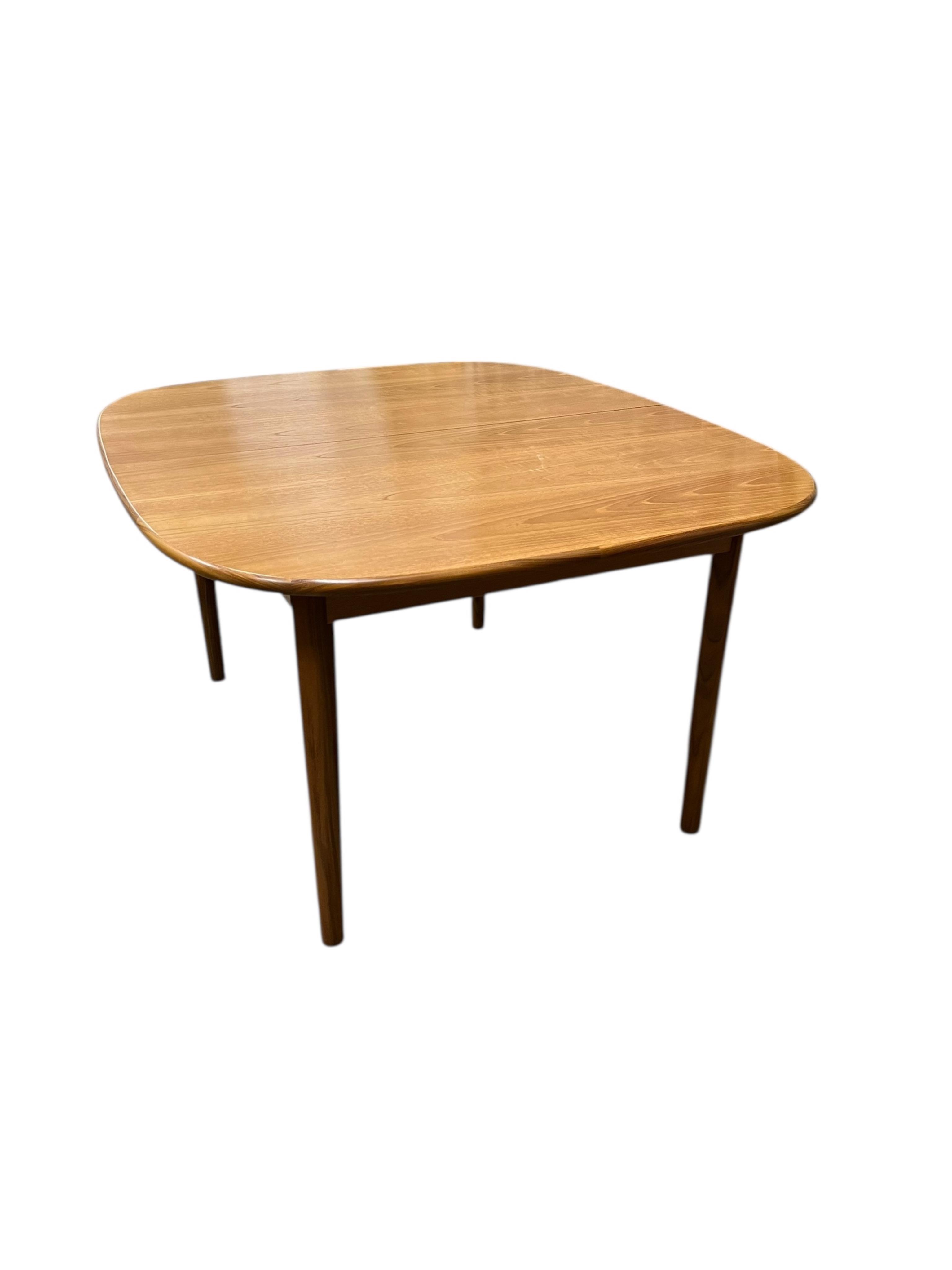 A mid century G Plan Fresco teak dining suite comprising dining table 184cm extended, depth 116cm, height 73cm, six chairs, two with arms and a four door sideboard, width 152cm